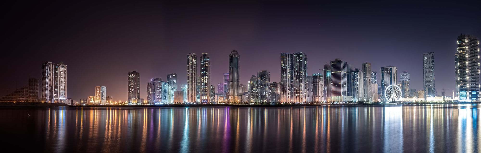 nighttime city skyline with tall buildings